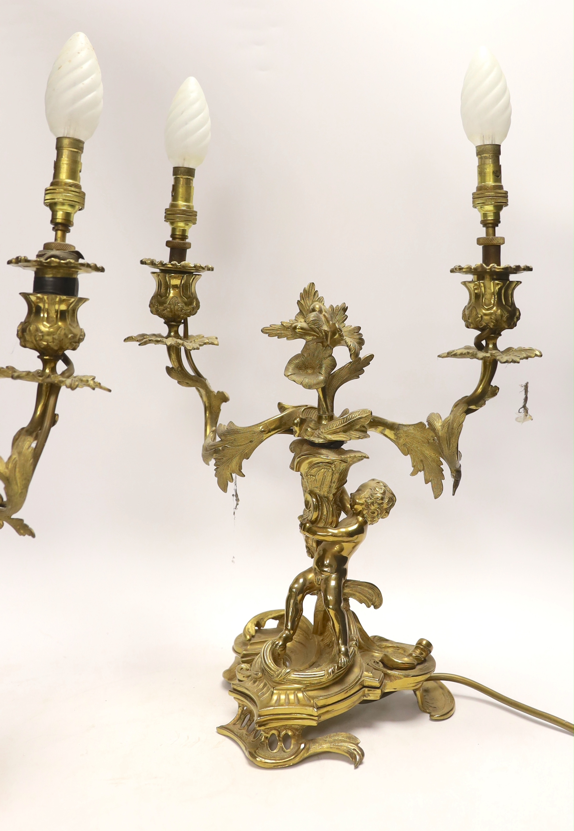 A pair of Victorian ormolu two branch candelabra, mounted as lamps, 48cm total including bulbs